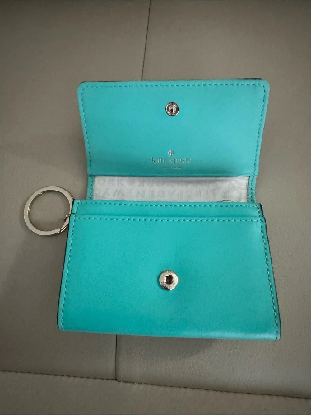 kate spade turquoise wristlet with gold logo